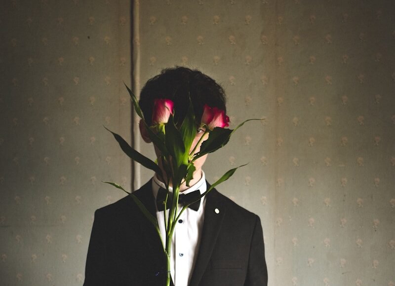 man holding red rose