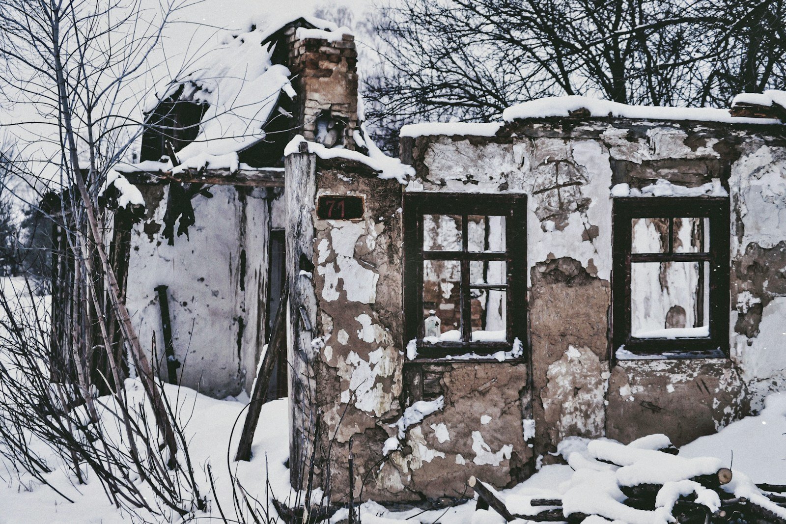 an old run down building covered in snow