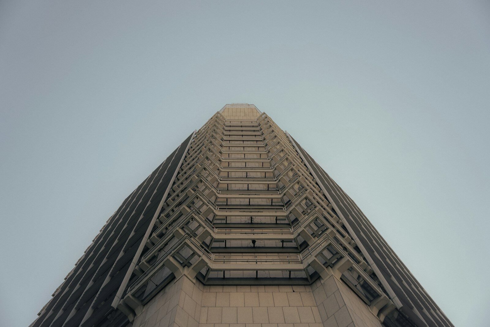 Geometric skyscraper facade against a clear sky