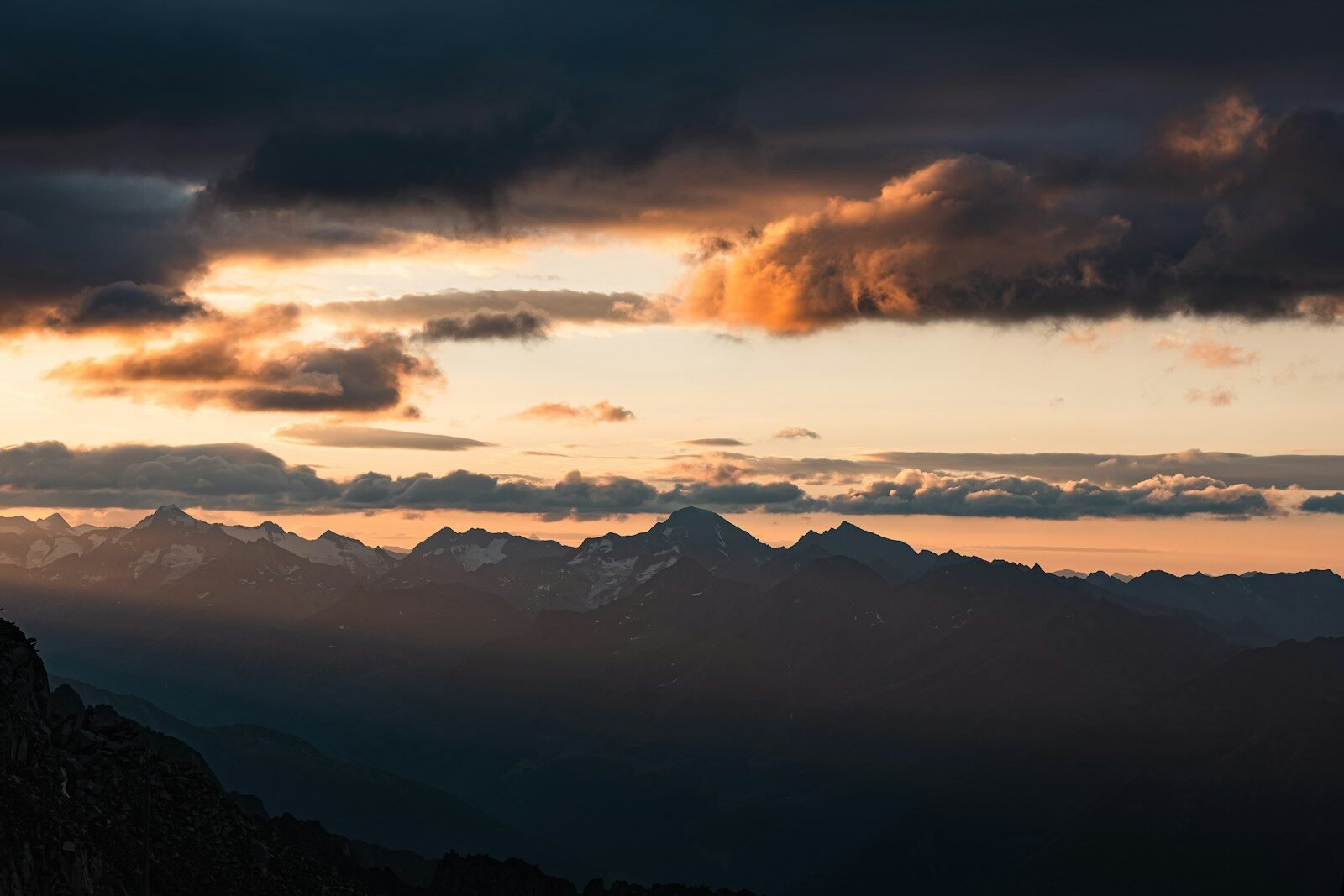 Majestic mountains silhouetted against a dramatic sunset sky.